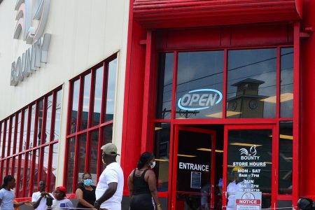 The Bounty Supermarket on Regent Street was seen opened with customers outside waiting in line to enter the establishment as the company put measures in place to promote social and physical distancing (Orlando Charles photo) 