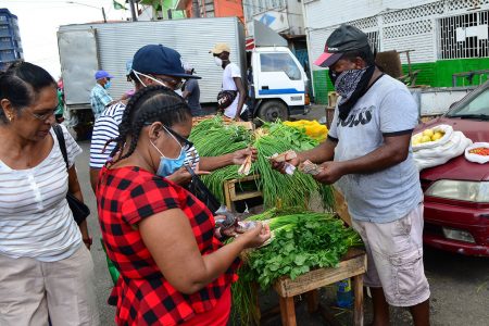 ‘Masked up’ citizens purchasing food items at Bourda Market 