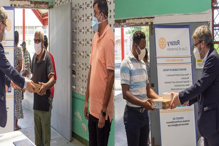 Ambassador of the European Union (EU) to Guyana Fernando Ponz Cantó, in collaboration with the Rotary Club of Demerara, made an urgent donation of personal computers, smartphones, tablets and sanitation and food hampers to the Deaf Association of Guyana and to the Guyana Society for the Blind yesterday. The donated pieces of electronic equipment were part of the reserve library of electronics of the recent EU Electoral Observation Mission (EUEOM) to Guyana for the March 2, 2020 polls. In a release, the EU Delegation said it expects that the devices will significantly aid the beneficiary persons in their communication needs and contribute to the existing educational programmes they each conduct, especially during this period where movement and regular daily activities are restricted due to the COVID-19 pandemic. The hampers were put together from donations and by the Rotarians. According to the release, the equipment will enable the Deaf Association of Guyana and to continue its efforts towards improving the formal education offered to deaf students and to ensure accessibility to information and in other aspects of private and social life. It added that the Guyana Society for the Blind will be able to further its CXC educational programmes, among other things. President Hansraj Singh of the Rotary Club of Demerara similarly remarked that “we are happy to collaborate on this initiative. This unprecedented pandemic in Guyana requires coordinated efforts from us all, whether it be helping vulnerable groups or encouraging others to observe recommended measures. We thank the EU for partnering with us and encourage others to continue to consider their fellow man as we continue to demonstrate service above self.” From left in this composite photo, Ambassador Cantó hands over part of the donation to Cecil Morris and Ganesh Singh of the Guyana Society for the Blind and Quincy Richards of the Deaf Association.. (European Union Delegation photo)