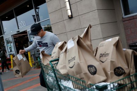 Excelso Sabulau, a 35-year-old independent contract delivery driver for Amazon Flex, wears a protective mask as he carried deliveries to his car near a Whole Foods Market, as the spread of the coronavirus disease (COVID-19) continues, in Dublin, California, U.S., on April 6, 2020. (REUTERS/Shannon Stapleton photo)
