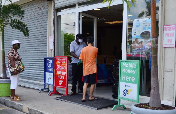 A customer sanitising before entering Gizmos and Gadgets