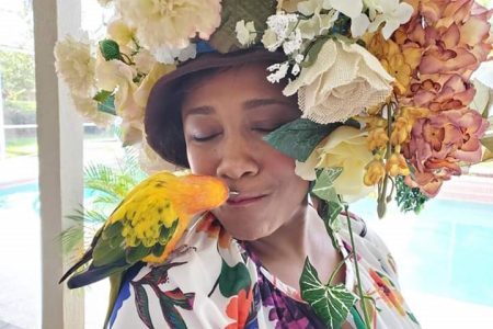 Guenet Gittens-Roberts with her parrot Phoebe wearing her hat dubbed ‘Afternoon in the City’.