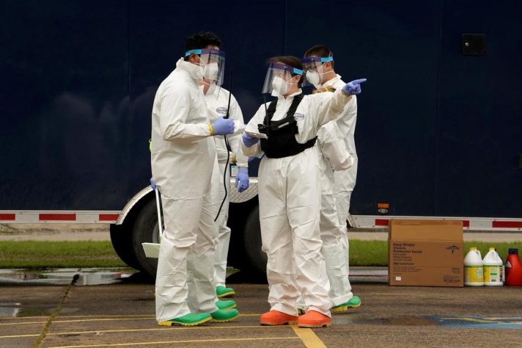 Oklahoma National Guardsmen receive orders during a decontamination mission at a longterm care facility, amid the spread of the coronavirus disease (COVID-19), in McAlester, Oklahoma, U.S. April 22, 2020. REUTERS/Nick Oxford
