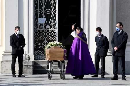 FILE PHOTO: A priest blesses the coffin of a woman who died from coronavirus disease (COVID-19) at her funeral, as Italy struggles to contain the spread of coronavirus disease (COVID-19), in Seriate, Italy March 28, 2020. REUTERS/Flavio Lo Scalzo