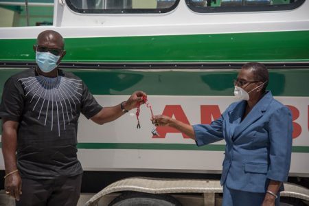 John Adams (left), Technical Advisor to the Public Health Ministry hands over the keys to the river ambulance to Regional Health Officer, Region Ten, Dr. Pansy Armstrong. (DPI photo)
