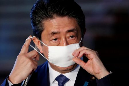 Japan's Prime Minister Shinzo Abe adjusts his face mask as he arrives to speak to the media on Japan's response to the coronavirus disease (COVID-19) outbreak, at his official residence in Tokyo, Japan, April 6, 2020. REUTERS/Issei Kato/File Photo