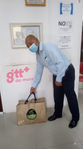 Dr Justo from the Oncology Department of GPHC receiving one of the care packages (GTT photo)