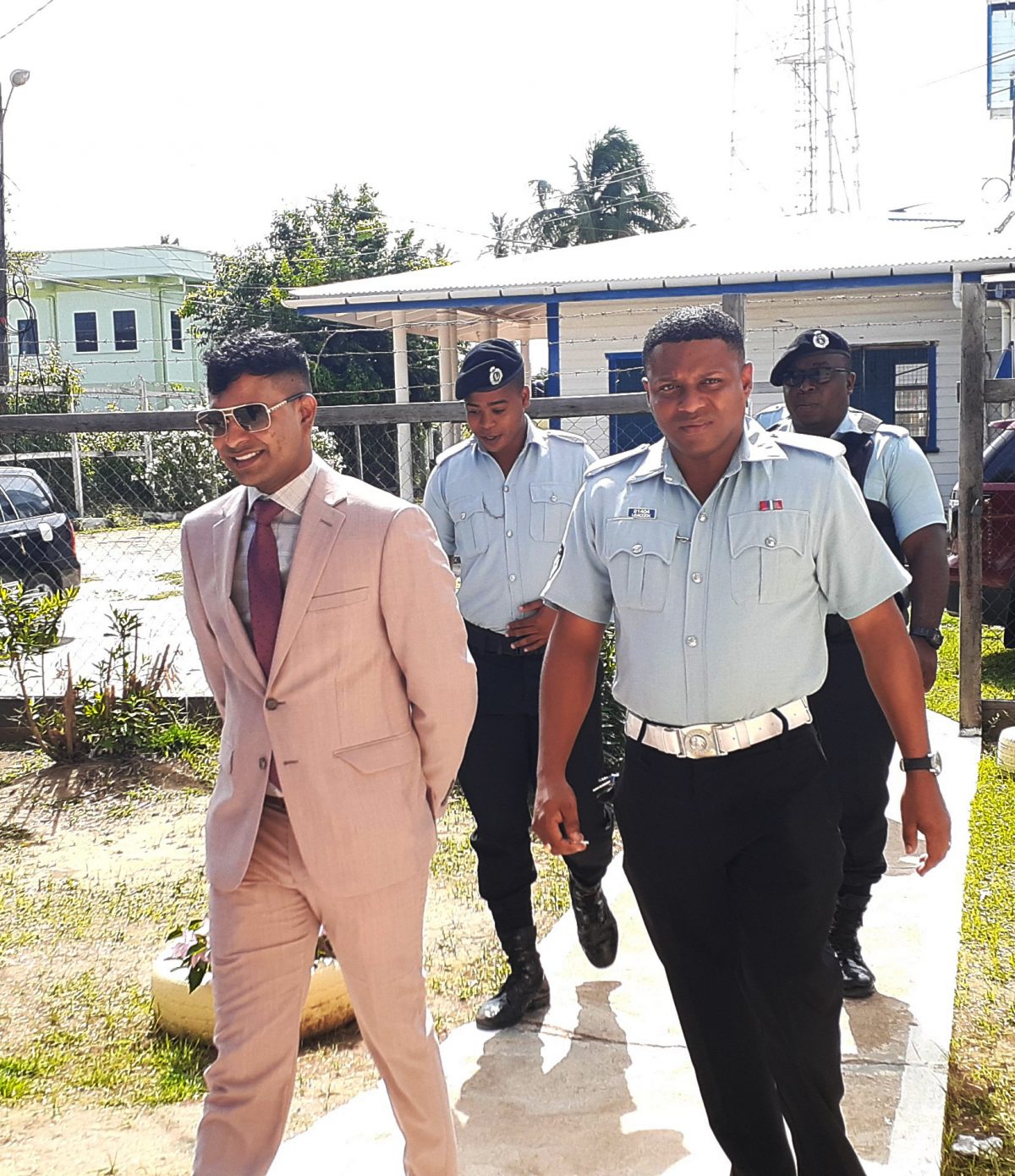 Marcus Brian Bisram (left) arriving at court yesterday
