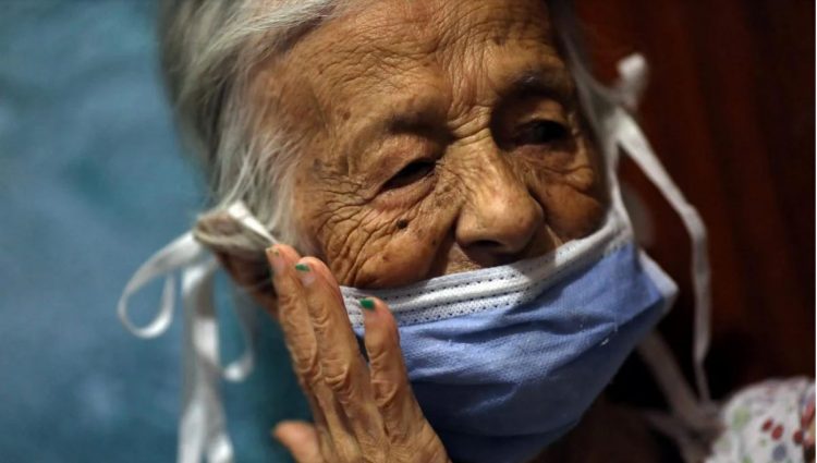 Maria Araque, 90, wears a protective mask at her house during the nationwide quarantine due to the coronavirus disease (COVID-19) outbreak in Caracas, Venezuela March 25, 2020. Picture taken March 25, 2020. REUTERS/ Manaure Quintero
