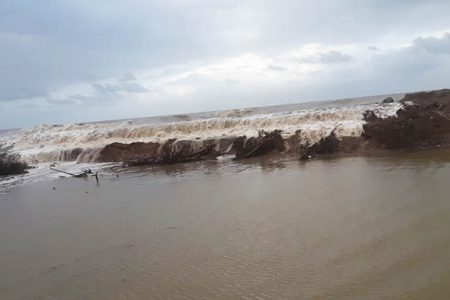 Waves overtopping the eroding section of sea defence at Content, Mahaicony last week (Stabroek News file photo)
