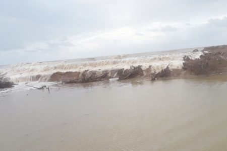 Waves overtopping the eroding section of sea defence at Content, Mahaicony 