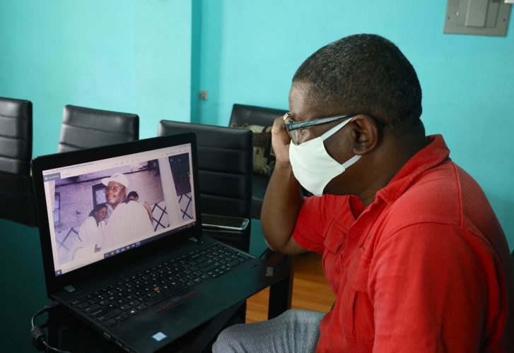 A sad Robert Paris, councillor for Pleasantville, San Fernando, looks at a photograph of his uncle Winford Atherley who lived in from Brooklyn New York. Atherley died from the COVID-19 virus.