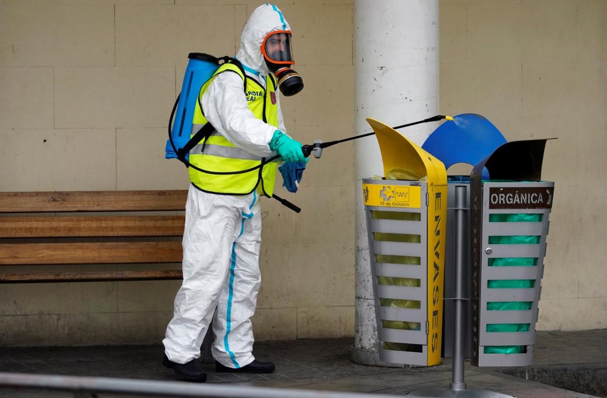 FILE PHOTO: A member of the Royal Guard wearing protective gear sanitises a dumpster outside the emergency unit at 12 de Octubre Hospital, amid the coronavirus disease (COVID-19) outbreak in Madrid, Spain March 30, 2020. REUTERS/Juan Medina