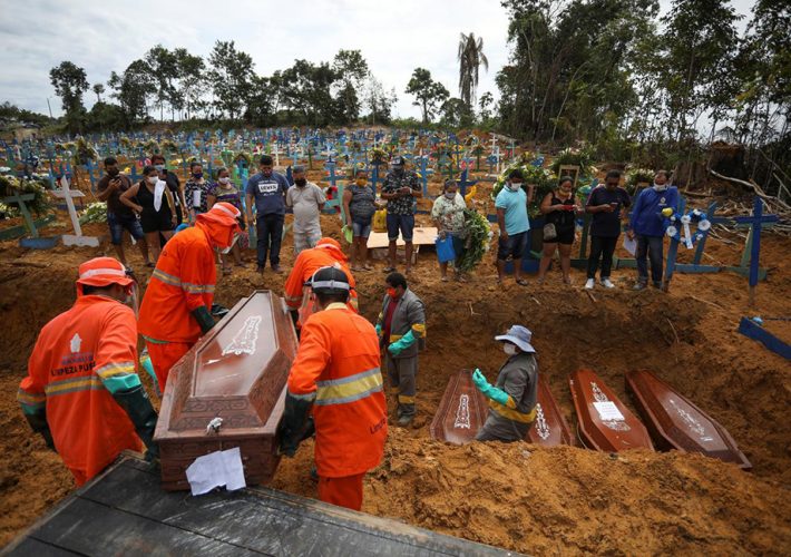 Gravediggers carry a coffin during a collective burial of people that have passed away due to the coronavirus disease (COVID-19), at the Parque Taruma cemetery in Manaus, Brazil April 28, 2020. Picture taken April 28, 2020. REUTERS/Bruno Kelly