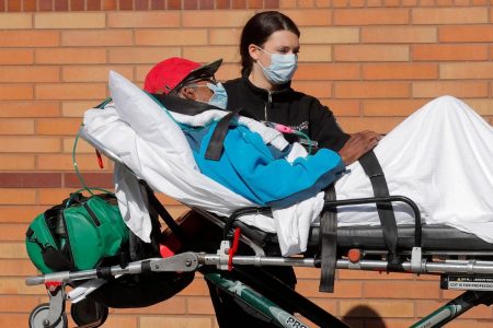 A healthcare worker wheels a patient on a stretcher into the Wyckoff Heights Medical Center during the outbreak of the coronavirus disease (COVID-19) in the Brooklyn borough of New York City, New York, U.S., April 6, 2020. REUTERS/Brendan Mcdermid
