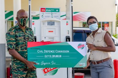 The cheque being presented to a representative of the CDC (left) (Rubis photo)
