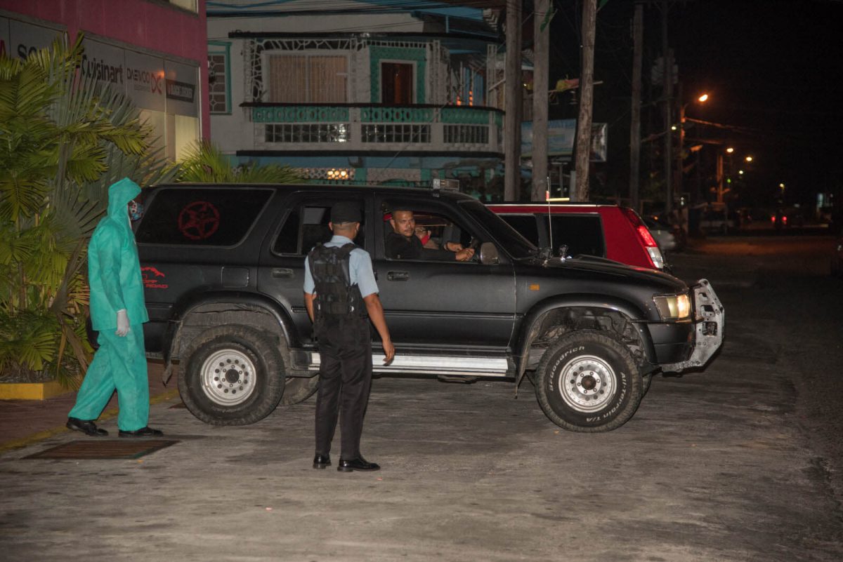 Police ranks during a nighttime patrol to enforce the national curfew. Over 40 have been arrested in Region Four for violating the 6pm to 6am COVID-19 curfew. See story on page 16. (DPI photo) 