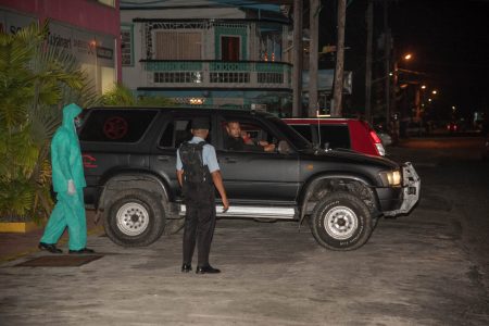 Police ranks during a nighttime patrol to enforce the national curfew. Over 40 have been arrested in Region Four for violating the 6pm to 6am COVID-19 curfew. See story on page 16. (DPI photo) 