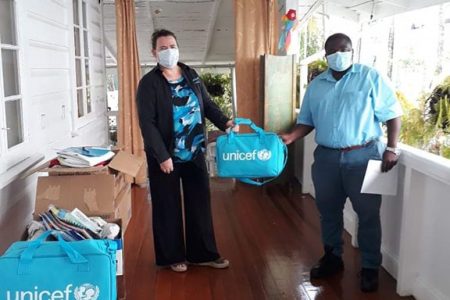 UNICEF Representative Sylvie Fouet ( at left) on Friday handed over a donation of sanitizer gel, disinfectant spray, a complete bed for teens and board games among other supplies to the Ministry of Public Health. Deputy Director of Health Emergency Operations Dr. Leston Payne received the donation on behalf of the Ministry of Public Health. In a post on its Facebook page, the ministry said UNICEF is looking forward to supporting the government in improving its COVID-19 response capacity, by increasing focus on addressing the needs of children and adolescents in humanitarian situations. (Ministry of Public Health photo)