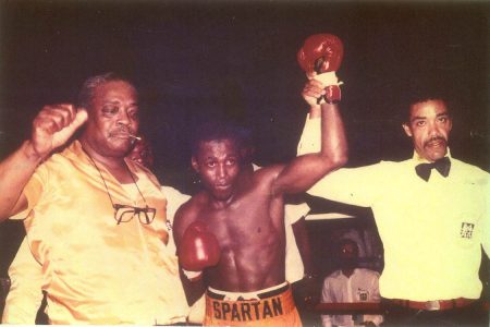 Referee Eion Jardine raises the hand of Terrence Alli in victory after he defeated Steve Larrimore at the Georgetown Cricket Club ground, Bourda on June 13, 1992.