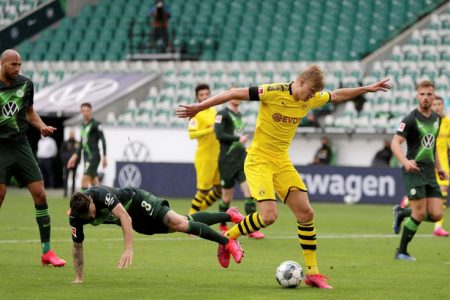 Borussia Dortmund’s Erling Haaland in action yesterday with VfL Wolfsburg’s Renato Steffen, as play resumes behind closed doors following the outbreak of the coronavirus disease (COVID-19) Michael Sohn/Pool via REUTERS
