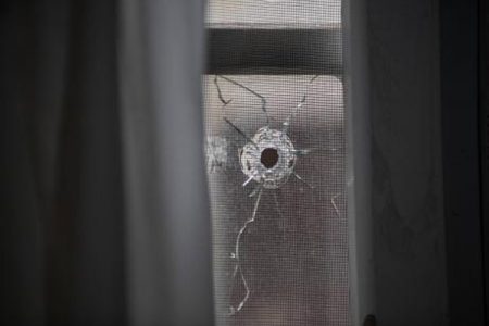 One of numerous bullet holes left at a home on Bryce Hill Road, August Town, St Andrew, yesterday. Attackers sprayed bullets into the home the previous night injuring three of the occupants including an eight-year-old.
