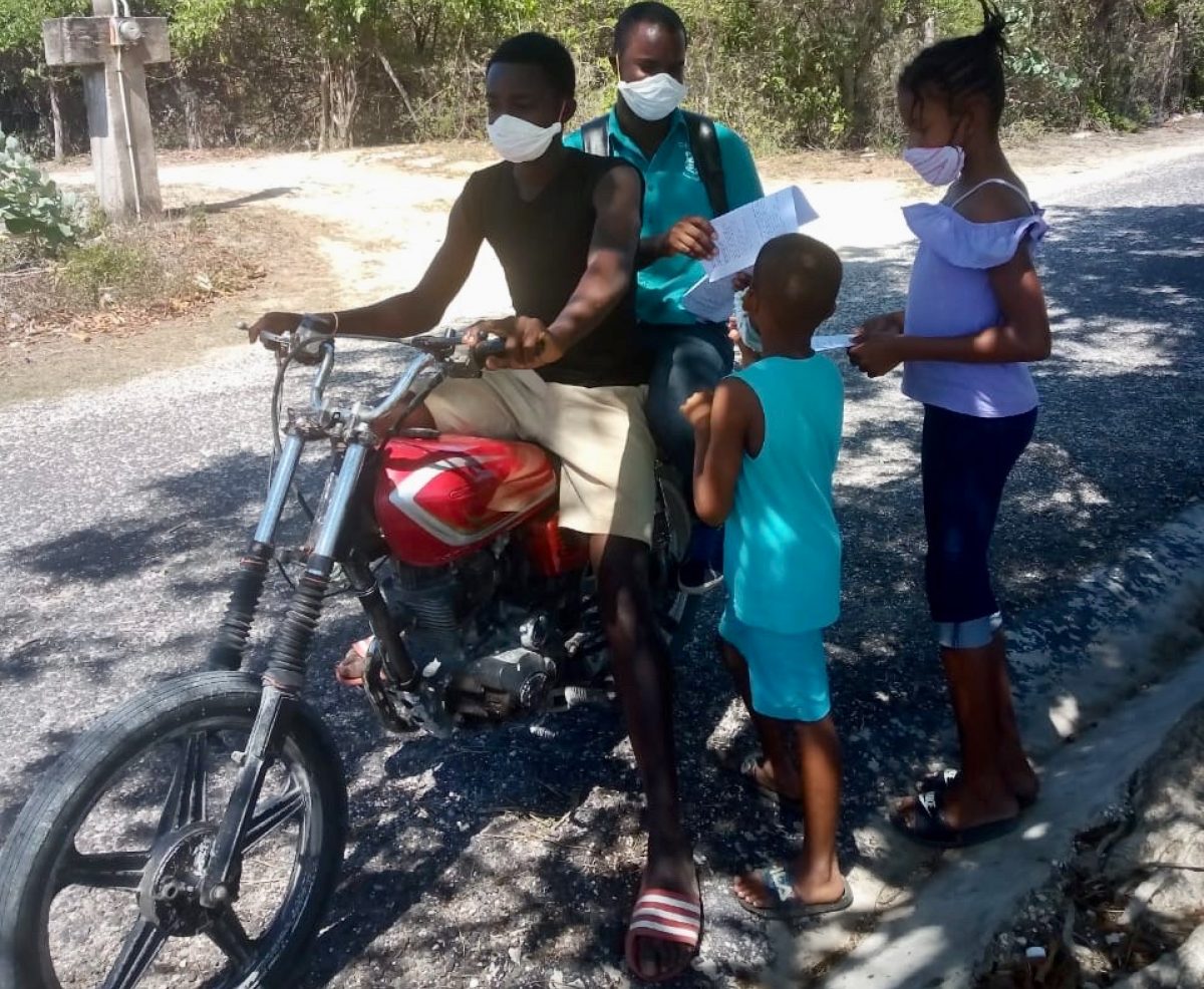 Keron King, Principal of Little Bay Primary School in Westmoreland, delivering and picking up homework by motorbike during the COVID-19 outbreak.