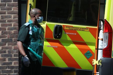 A medical worker wearing personal protective equipment (PPE) at the back of an ambulance outside Lewisham hospital as the spread of the coronavirus disease (COVID-19) continues, London, Britain, April 20, 2020. REUTERS/Hannah McKay