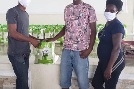 MYO representative Br. Jason hands over food hampers to Mr Leroy Phillips, member of the Visually Impaired and Persons with Disabilities Society. 
