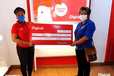 Louanna Abrams of Digicel hands over Cheque to Renata Chuck-A-Sang from the Rotary Club of Georgetown. (Digicel photo)