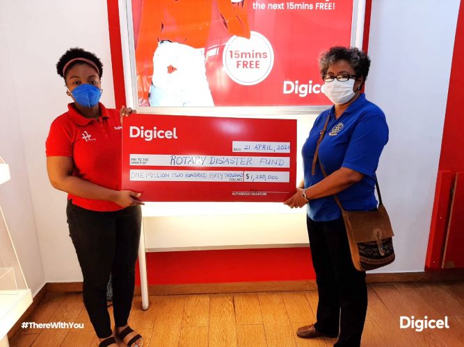 Louanna Abrams of Digicel hands over Cheque to Renata Chuck-A-Sang from the Rotary Club of Georgetown. (Digicel photo)