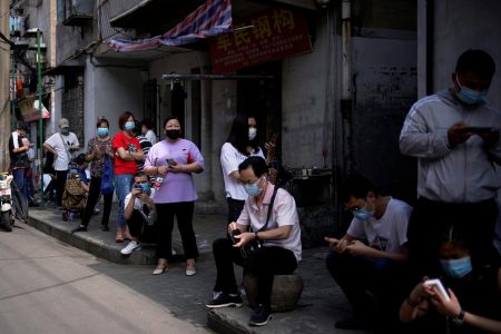Residents wearing face masks line up for nucleic acid testings at a residential compound in Wuhan, the Chinese city hit hardest by the coronavirus disease (COVID-19) outbreak, Hubei province, China May 17, 2020. REUTERS/Aly Song