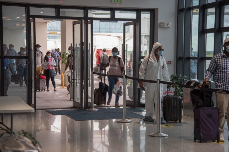 Returning Guyanese being processed at the CJIA on Friday (Department of Public Information photo)
