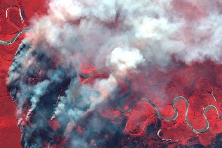Smoke rises from wildfires near Berezovka River in Russia in this June 23, 2020 color infrared image supplied by Maxar Technologies. Image taken June 23, 2020. (Maxar Technologies satellite image via REUTERS) 
