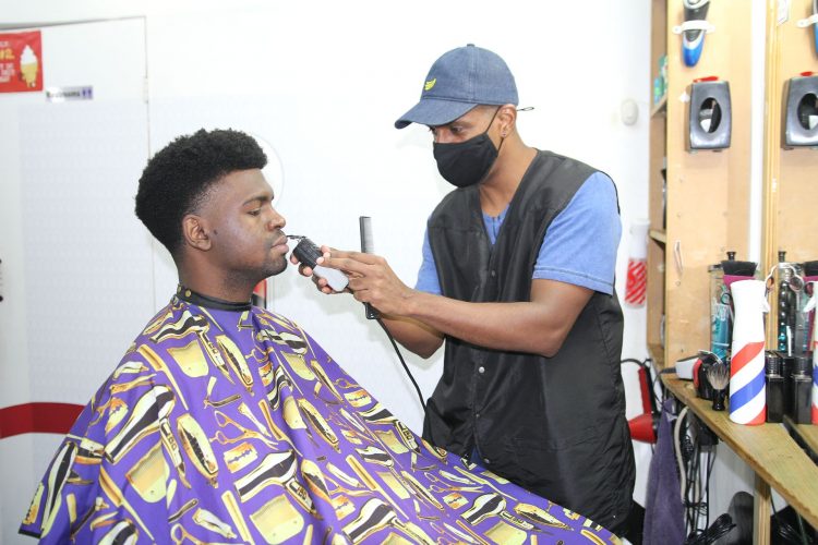 Ronald Roze a barber from the Barber Shop By Roze, on Vidale Street, St James, Port-of-Spain cut a client hair yesterday. This is one of the services will open on Monday as part of the Government's recovery plan phase 4 which was rolled out by the Prime Minister during a press conference.