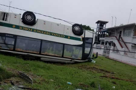 The overturned GDF bus on the side of the roadway