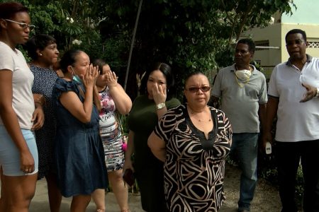 Family and friends of Joel Jacobs at their home in Second Caledonia, Morvant yesterday.