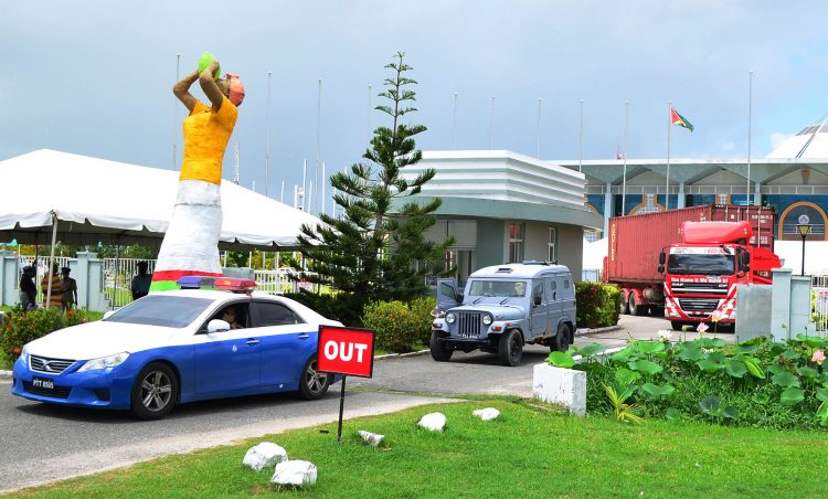 Back to base: A container with ballot boxes being escorted yesterday by the police to GECOM’s Kingston Headquarters following the conclusion of the recount of ballots from the March 2nd general elections.  (Orlando Charles photo)