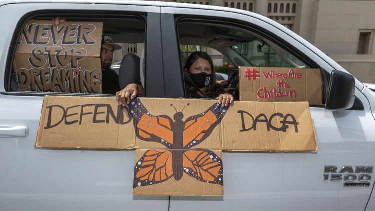 An immigrant family joins members of Coalition for Humane Immigrant Rights of Los Angeles on a vehicle caravan rally to support the Deferred Action for Childhood Arrivals (DACA) Program around MacArthur Park in Los Angeles on Thursday. DACA recipients reacted with a mixture of relief and gratitude over the Supreme Court ruling to reject President Donald Trump's effort to end legal protections for 650,000 immigrants under the DREAMers regime.