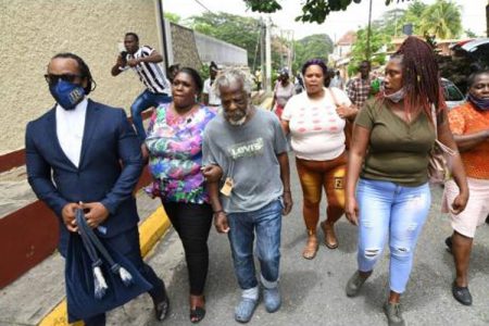 George Williams (centre) is accompanied by his niece, Pamela Green, and attorney Isat Buchanan in Spanish Town on Wednesday.