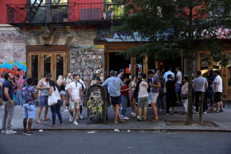 People drink outside a bar during the reopening phase following the coronavirus disease (COVID-19) outbreak in the East Village neighborhood of New York City, New York, U.S., June 13, 2020. REUTERS/Caitlin Ochs
