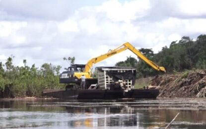 An excavator on a pontoon working to clear the Barrow trench (DPI photo)

