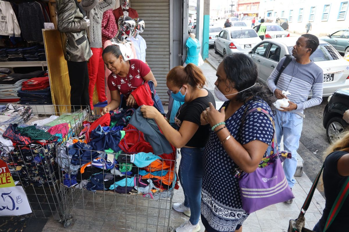 Customers browse through clothing at Shoppers’ World Limited on High Street in San Fernando yesterday.