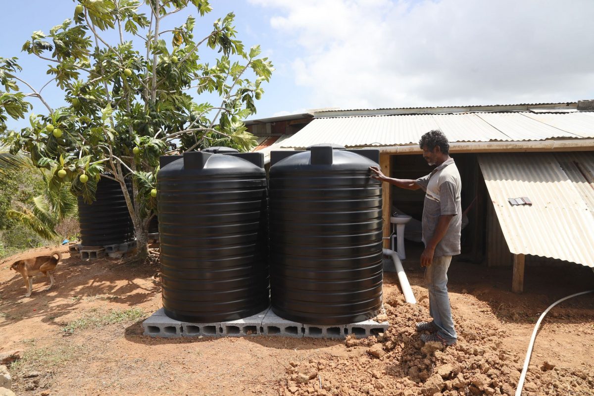 Teeluckdharry Seemungal shows  the water tanks donated by a Good Samaritan. 