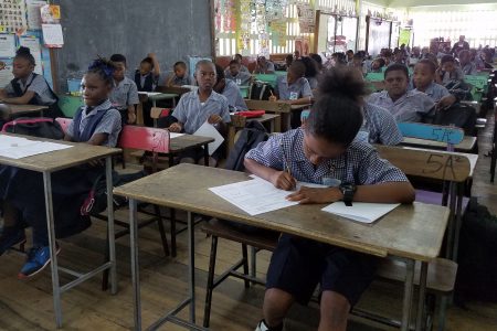 Students of Winfer Gardens preparing to write their mathematics mock exam in 2018. (Stabroek News file photo) 