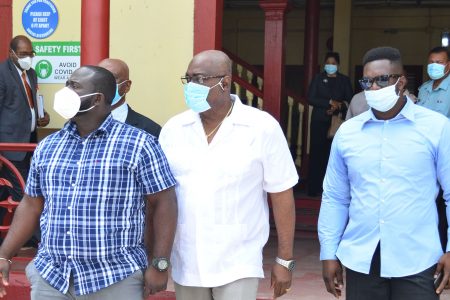 Chief Election Officer Keith Lowenfield (at centre) leaving the court after posting bail