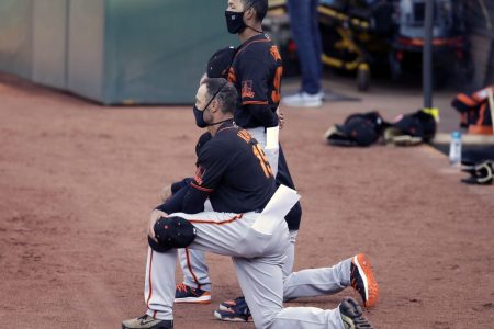 San Francisco Giants' manager Gabe Kapler kneels during the national anthem prior to an exhibition baseball game against the Oakland Athletics, Monday, July 20, 2020, in Oakland, Calif.(Ben Margot)