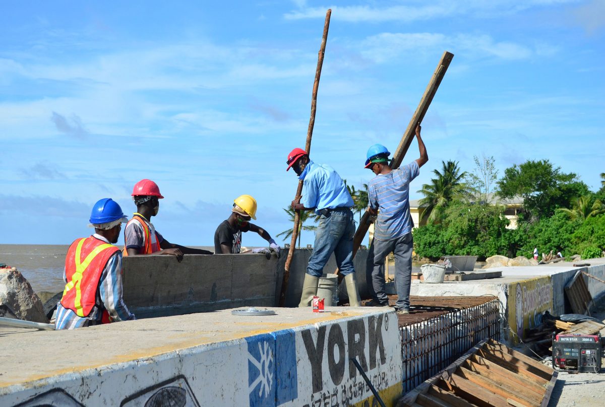 Workers bolstering Kitty sea defence: Rehabilitation works being done on the sea defence in the vicinity of the Kitty Pump Station yesterday. (Orlando Charles photo)