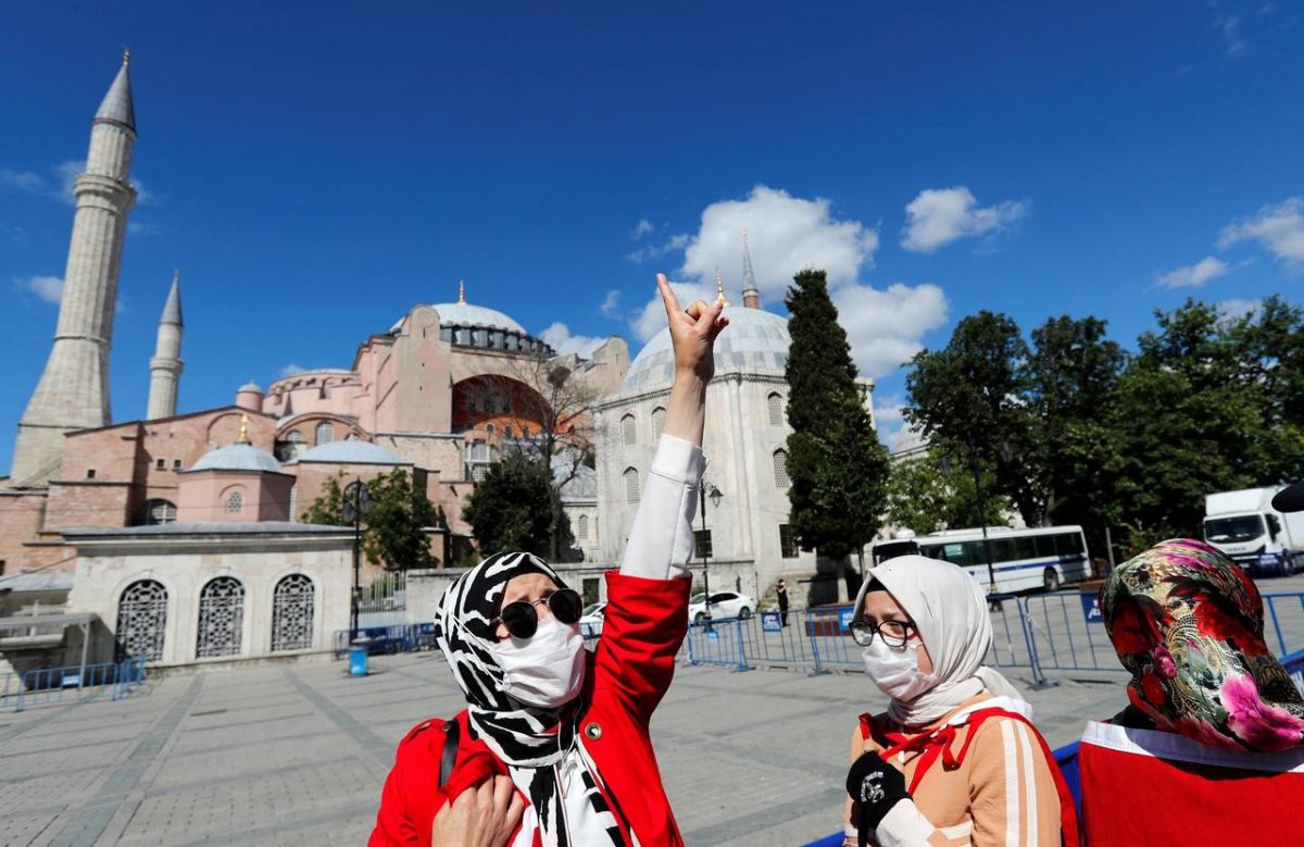 A woman gestures in front of the Hagia Sophia or Ayasofya, after a court decision that paves the way for it to be converted from a museum back into a mosque, in Istanbul, Turkey, July 10, 2020. REUTERS/Murad Sezer
