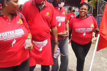 Retired Brigadier General Ancil Antoine, second from left, chats with supporters during a PNM walkabout on Saturday in La Horquetta/Talparo.